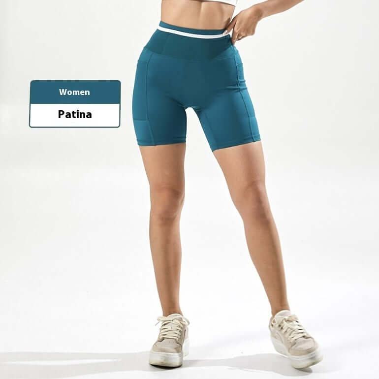 Women's compression shorts in teal color, designed for fitness and comfort, with high waistband for support.