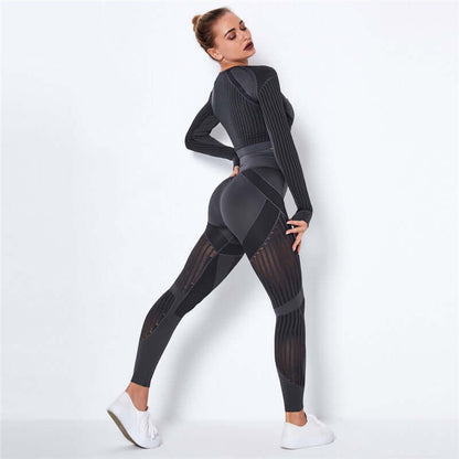 Woman wearing a stylish striped fitness set in black with white sneakers, demonstrating activewear fashion.