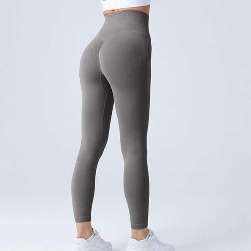 High-waisted gray workout running leggings shown in back view, size options S-L, ideal for fitness enthusiasts, worn with white shoes.