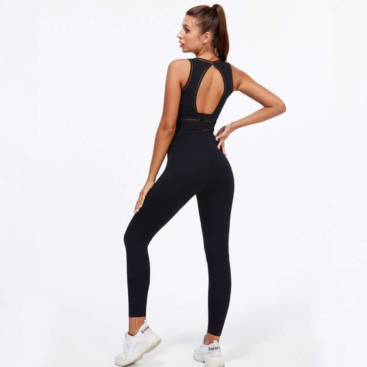 Woman wearing black hip-lifting peach trousers yoga fitness suit, showing back view with sleeveless top and supportive fit.